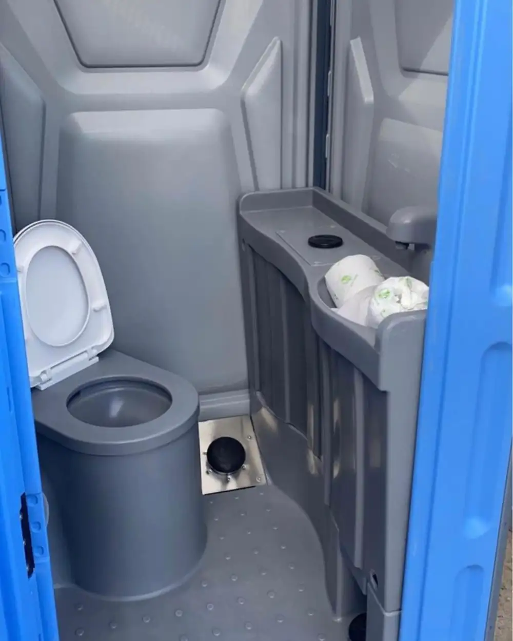 Deluxe porta potty interior with seat and built-in hand sink